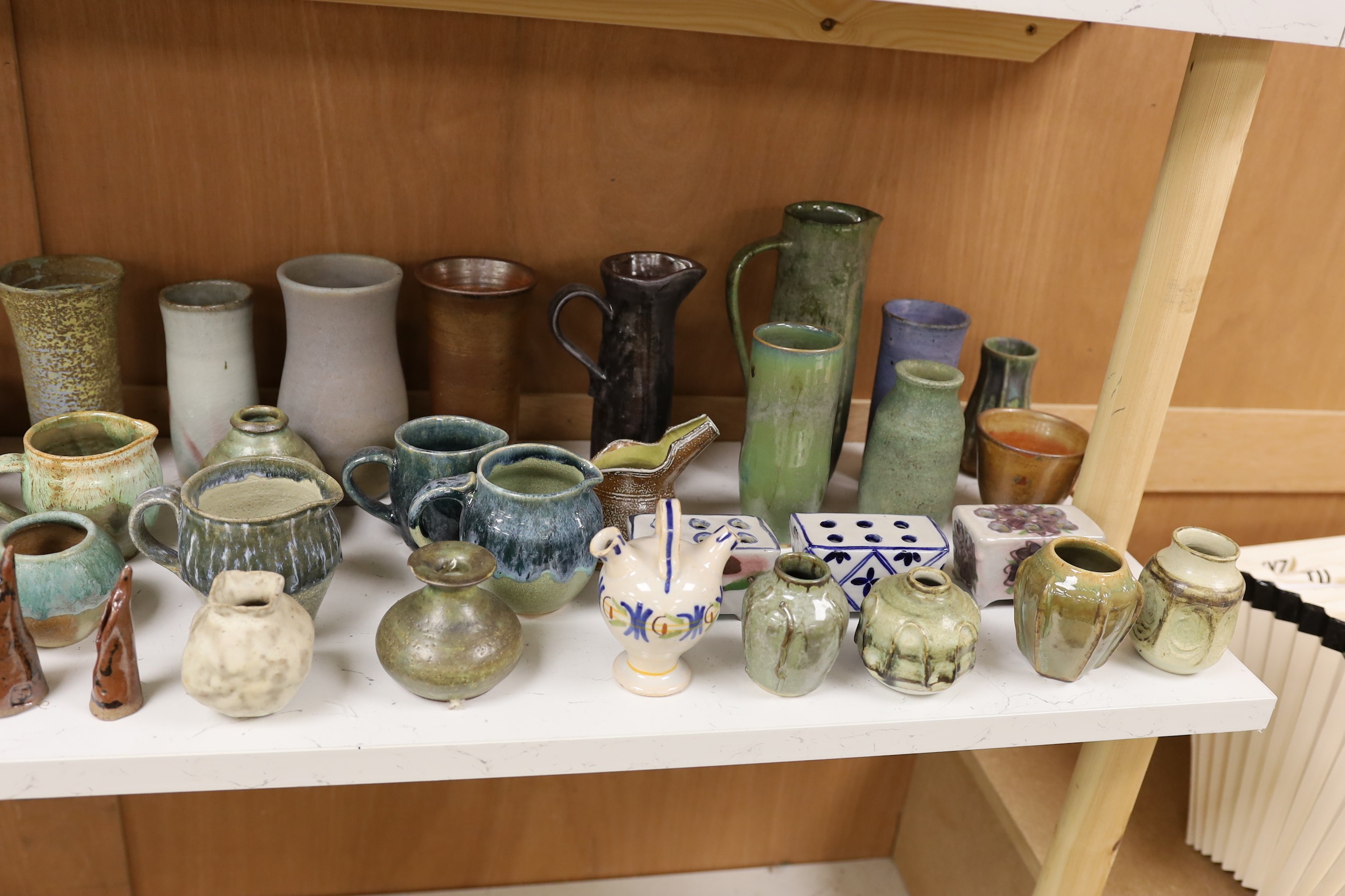 A large quantity of British studio pottery teapots, mugs, jugs and other miscellaneous items, to include a vast amount by Susan Threadgold
